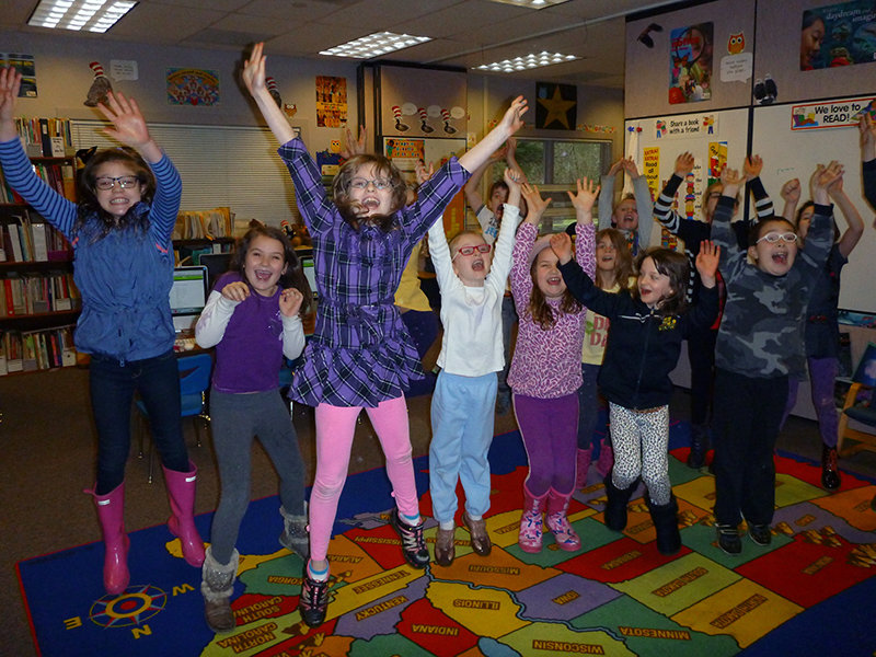 Point Roberts Primary School students jump for joy on learning that they will eventually be attending a remodeled high school.   Photo by Meg Olson